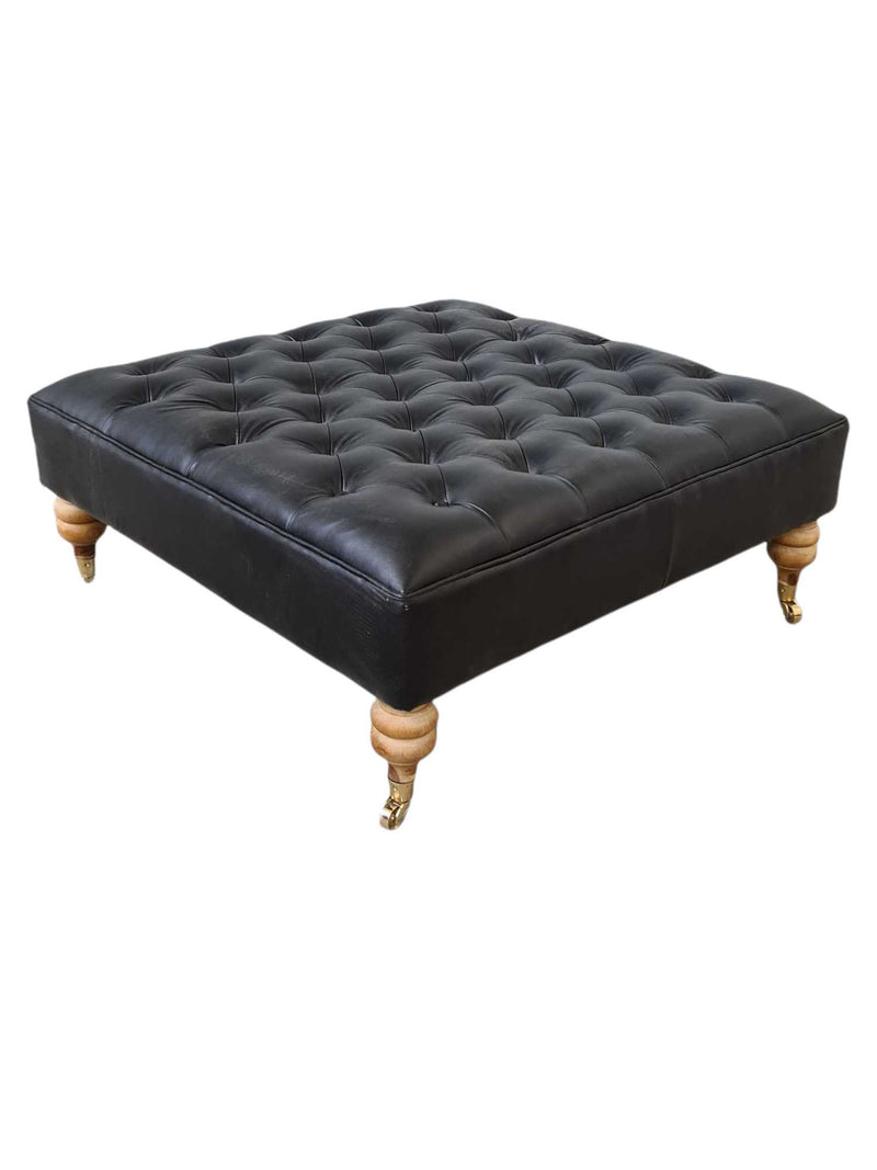 LINCOLN LEATHER OTTOMAN WITH BRASS WHEELS